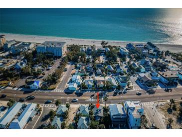 Charming neighborhood with beach access, showcasing a mix of homes and vibrant blue ocean views at 12409 Gulf Blvd, Treasure Island, FL 33706