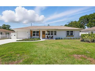 Charming single-story home with a well-maintained lawn, beautiful flower bed, and inviting curb appeal at 4219 26Th N Ave, St Petersburg, FL 33713