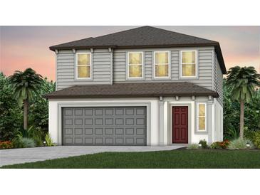 Charming two-story home featuring gray siding, a two-car garage, and a welcoming red front door at 9766 Crescent Moon Dr, Riverview, FL 33578