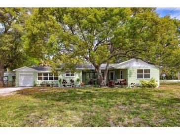 Charming single-story home with a well-manicured lawn and mature shade tree at 1984 Trotter Rd, Largo, FL 33774