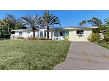 Charming one-story home featuring well-maintained lawn, palm trees, and a welcoming driveway at 22396 Nyack Ave, Port Charlotte, FL 33952