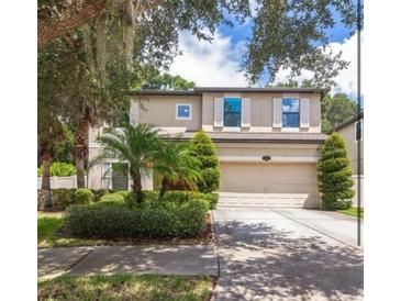 Charming two-story home boasts a well-manicured lawn and lush landscaping, enhancing its curb appeal at 309 Dakota Hill Dr, Seffner, FL 33584