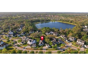 Beautiful aerial view of lakeside community with well-maintained lawns and mature trees at 5903 Nature Ridge Ln, Lithia, FL 33547