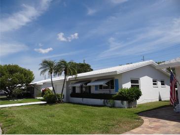 Charming single-story home with a well-manicured lawn and tropical landscaping in a sunny neighborhood at 9825 41St N St, Pinellas Park, FL 33782