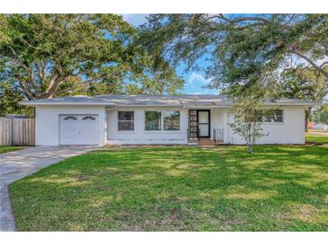 Charming single-story home with a well-maintained front yard and mature trees at 1432 S Keene Rd, Clearwater, FL 33756