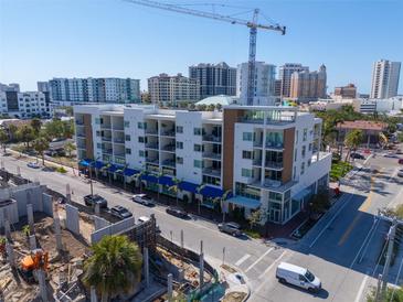 Stylish condo building with blue awnings on a sunny day at 332 Cocoanut Ave # 505, Sarasota, FL 34236