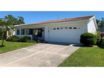 Charming single-story home featuring a two-car garage and well-maintained landscaping at 3928 90Th N Ter, Pinellas Park, FL 33782