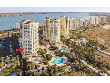 An aerial view of the condominiums and pool area with views of the bay and ocean at 1170 Gulf Blvd # 402, Clearwater, FL 33767