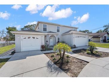 Charming two-story home with attached two-car garage and well-maintained landscaping on a sunny day at 11780 Linden Dr, Spring Hill, FL 34608