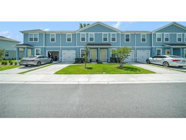 Charming two-story townhome with a well-manicured lawn and driveway at 12264 Grizzly Ln, New Port Richey, FL 34654