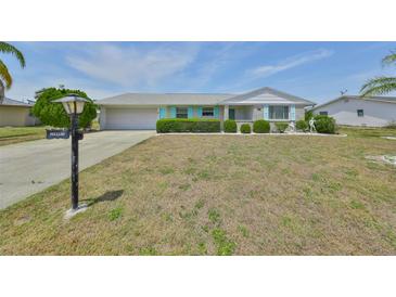 Charming single-story home with a well-maintained front yard and attached garage at 1809 Haverford Ave, Sun City Center, FL 33573
