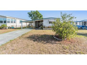 Charming single-story home featuring a covered parking area and a cozy screened-in porch at 37229 Cora Ave, Zephyrhills, FL 33542