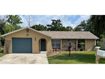 Charming single-story home with a stone accent wall, well-maintained lawn, and attached garage at 8317 Needles Dr, Hudson, FL 34667