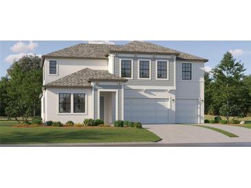 New construction two-story home featuring an attached three car garage and manicured lawn at 9645 Runaway Breeze Dr, Land O Lakes, FL 34637