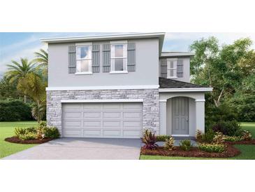 Charming two-story home with stone accents, a gray facade, shutters, and a two-car garage at 32730 Winterwood Boulevard Blvd, Wesley Chapel, FL 33543