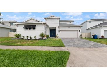Charming home with a well-manicured lawn and a neatly paved driveway at 8946 Ivy Stark Blvd, Wesley Chapel, FL 33545