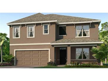 Two story home featuring a two car garage, and a neutral stucco exterior with white trim at 35670 Lockman Way, Zephyrhills, FL 33541