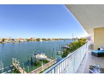 Waterfront condo view from balcony showcasing boat docks and serene blue waters with clear skies at 600 Bayway Blvd # 304, Clearwater, FL 33767