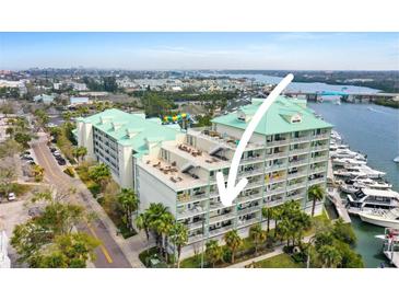 Condominium building featuring private balconies with views of the bay and docks at 399 C 2Nd St # 313, Indian Rocks Beach, FL 33785