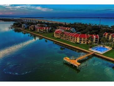 Beautiful aerial view of waterfront property with a dock and community pool at 7540 Sunshine Skyway S Ln # 217, St Petersburg, FL 33711