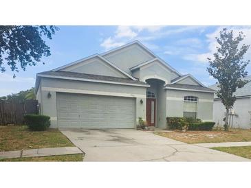 Charming single-Gathering home featuring a two-car garage and well-maintained front yard at 13231 Cherry Bark Cir, Riverview, FL 33579