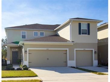 Charming two-story home featuring a two-car garage and neutral colored siding at 3000 Jacob Crossing Ln, Holiday, FL 34691