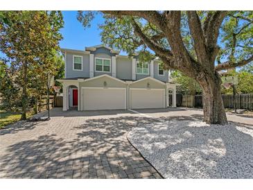 Charming two-story home featuring a brick driveway and mature landscaping, including a large shade tree at 1008 S Armenia Ave # A, Tampa, FL 33629
