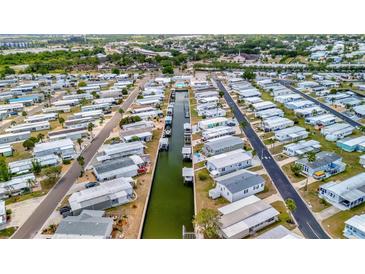 An aerial view of a waterfront community with canals and neatly arranged mobile homes at 119 E Saint Johns Way, Apollo Beach, FL 33572