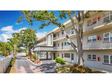 Well maintained condo building with mature trees, landscaping, and covered parking at 5890 38Th N Ave # 305, St Petersburg, FL 33710