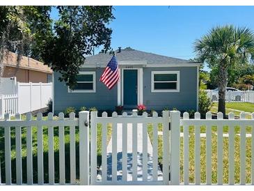 Charming single-story home with a well-manicured lawn and a classic white picket fence at 6401 30Th N Way, St Petersburg, FL 33702
