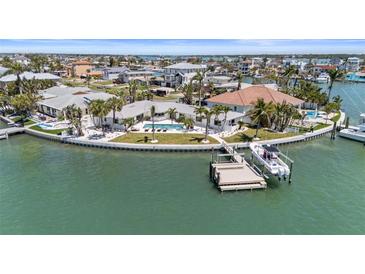 Waterfront home featuring a pool and boat dock on a picturesque canal, perfect for the boating enthusiast at 11050 7Th E St, Treasure Island, FL 33706