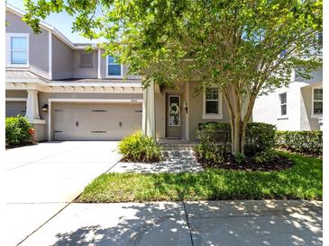 Charming two-story home featuring a well-manicured lawn and an attached two-car garage at 14616 Rocky Brook Dr, Tampa, FL 33625