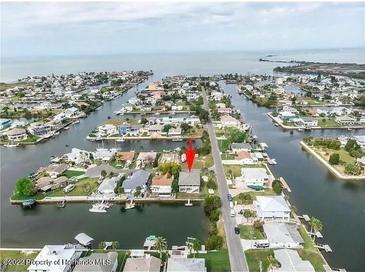 Stunning aerial view of waterfront property with access to canal and beautiful views at 4396 5Th Isle Dr, Hernando Beach, FL 34607