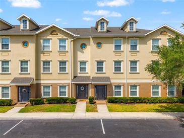 Attractive exterior of the multi-Gathering home with parking, manicured landscaping, and decorative doors at 10144 Arbor Run Dr # 139, Tampa, FL 33647