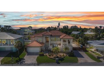 Stunning home with a red tile roof, a manicured lawn, and inviting outdoor living spaces at 107 Sunset Dr, Nokomis, FL 34275