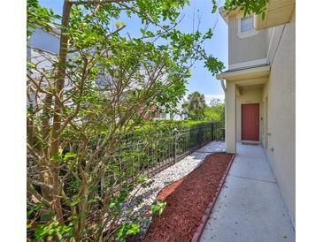 Inviting townhome entrance with well-maintained landscaping and a charming red front door at 11029 Winter Crest Dr Dr, Riverview, FL 33569