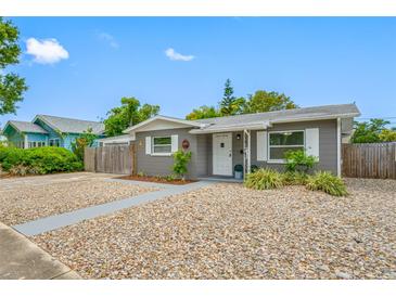 Charming single-story home with gray exterior, white trim, and fresh rock landscaping at 1120 45Th N St, St Petersburg, FL 33713