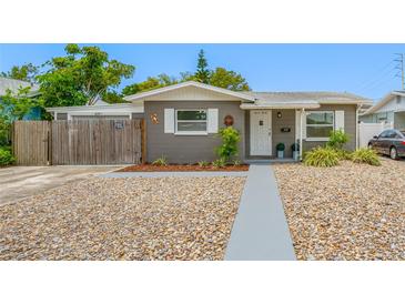 Charming single-story home with gray exterior, white trim, stone landscaping, and a welcoming front door at 1120 45Th N St, St Petersburg, FL 33713