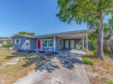 Charming one-story home with covered parking, red door, and freshly painted exterior at 11397 122Nd Ave, Largo, FL 33778