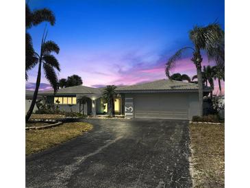Charming single-story home with a two-car garage, mature landscaping, and a well-maintained driveway at 1311 Sea Gull S Dr, St Petersburg, FL 33707