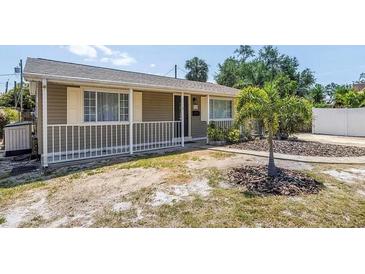 Charming single-story home with neutral siding, white picket fence, and a well-manicured lawn at 2719 Boca Ciega N Dr, St Petersburg, FL 33710