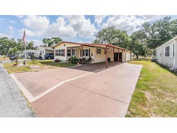 Inviting single-story home boasts a covered carport and well-maintained front yard at 5524 Betmar Dr, Zephyrhills, FL 33542