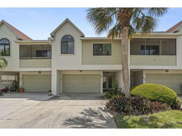 Charming two-story townhome with a well-manicured lawn and a one-car garage at 621 Duchess Blvd, Dunedin, FL 34698