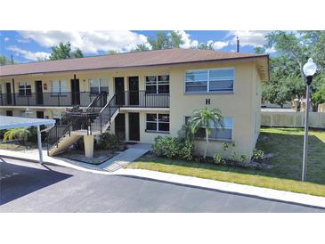 Charming two-story condo building with well-maintained landscaping and convenient carport parking for residents at 2501 Harn Blvd # H39, Clearwater, FL 33764