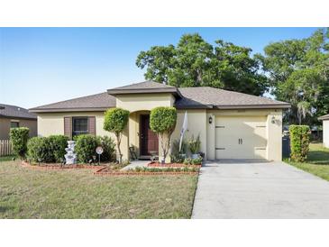 Charming single-story home featuring a well-manicured lawn and tidy landscaping at 26377 Bertram Rd, Brooksville, FL 34602