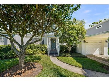 Charming home featuring a landscaped yard, welcoming entryway, and attached garage, perfect for curb appeal at 3711 W Dale Ave, Tampa, FL 33609