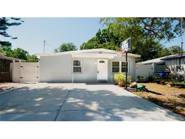 Charming single-story home with a well-manicured lawn, basketball hoop, and a long driveway at 7428 36Th N Ave, St Petersburg, FL 33710