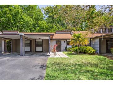 Charming single-story home with a covered parking and a cozy front yard and landscaping at 11536 Baywood Meadows Dr # 3, New Port Richey, FL 34654