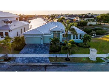 Charming waterfront home boasting lush landscaping, a paver driveway, and a durable metal roof at 5603 Tybee Island Dr, Apollo Beach, FL 33572