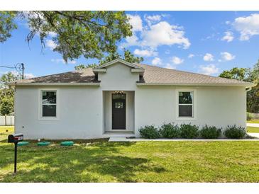 Charming single-story home featuring a well-manicured lawn, fresh exterior paint, and modern details at 7603 Rhode Island Dr, Tampa, FL 33619